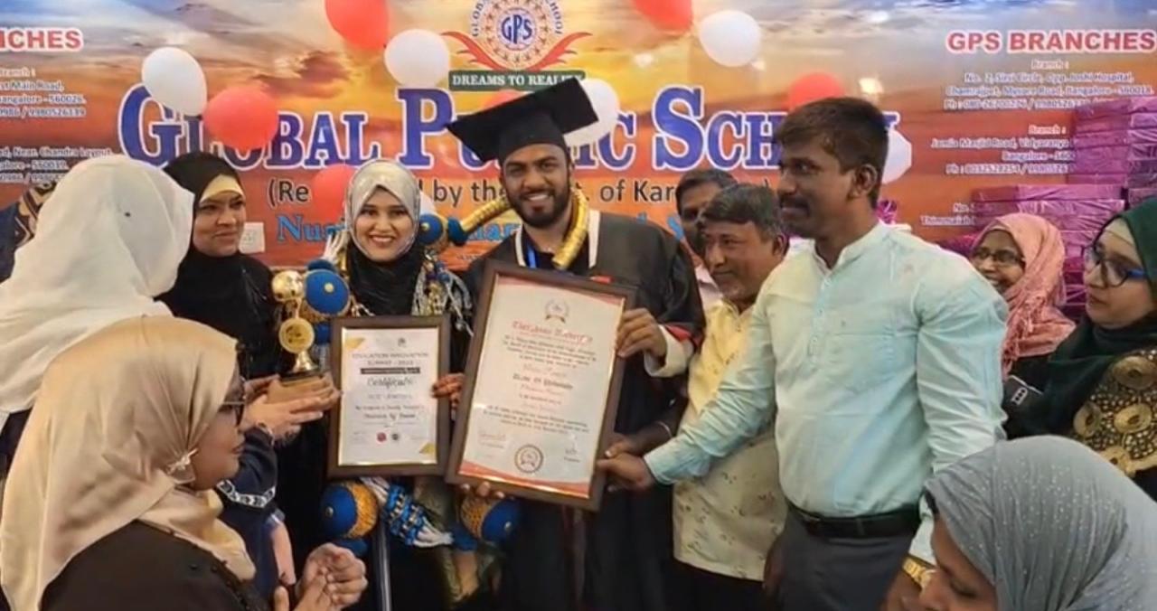 Graduate and staff with award certificates