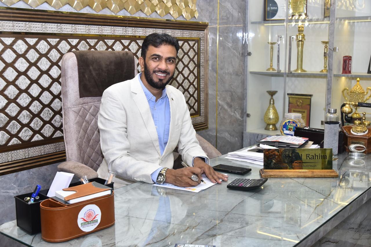 School chairman seated at his office desk